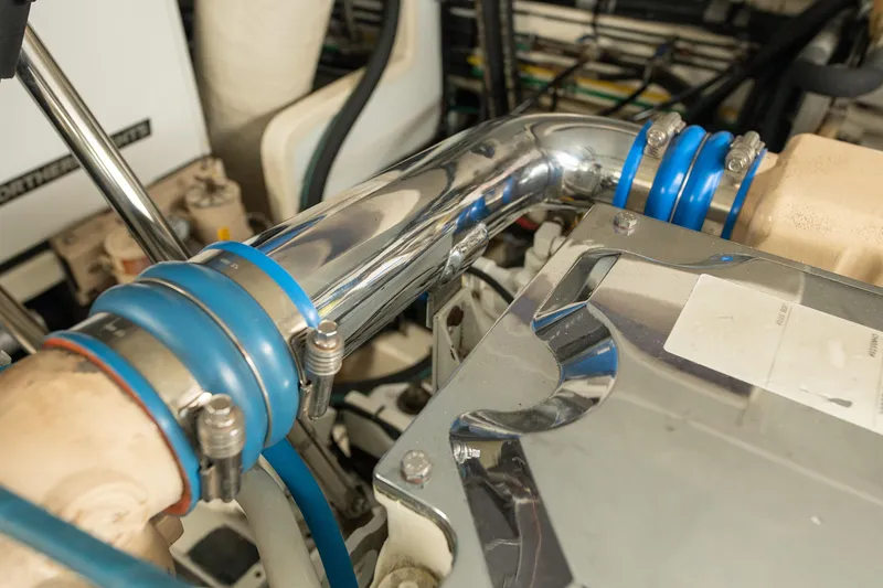 Slide: The Image of Engine room of 2003 Ocean Alexander 700 Classicco yacht, featuring polished metal pipes. - 54