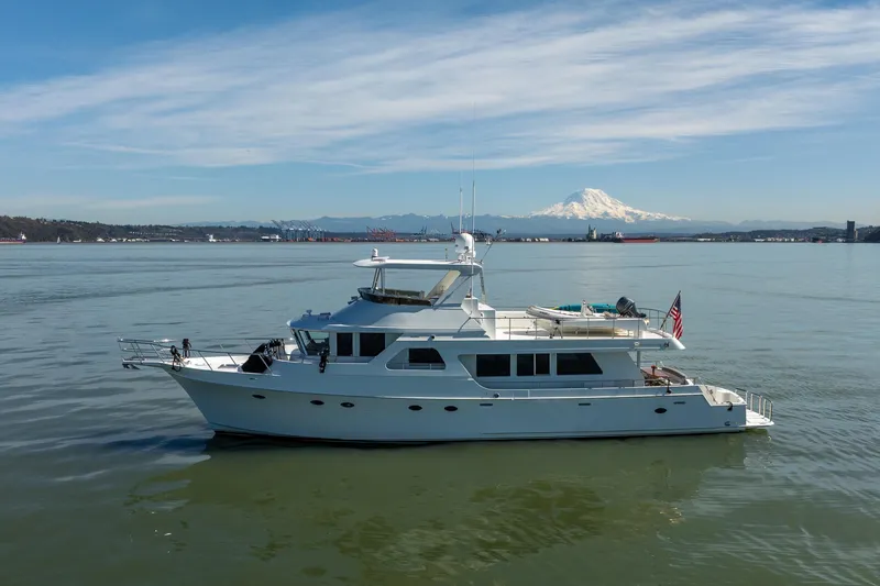 Slide: The Image of 2003 Ocean Alexander 700 Classicco yacht on calm waters with scenic mountain backdrop. - 57