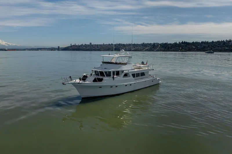 Slide: The Image of 2003 Ocean Alexander 700 Classicco yacht cruising on calm waters under a clear sky. - 59