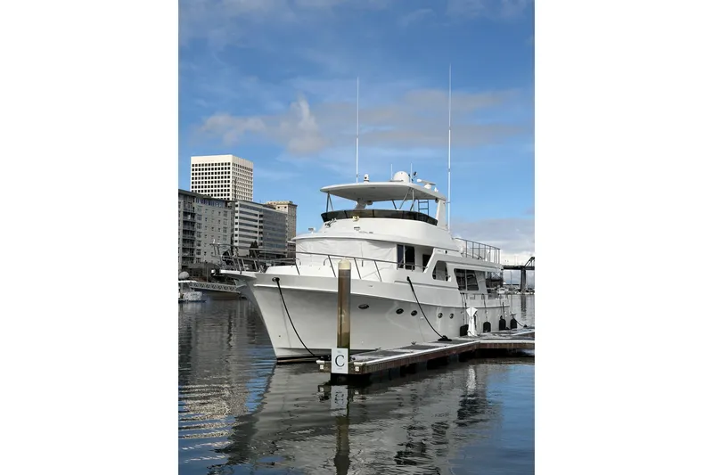 Slide: The Image of 2003 Ocean Alexander 700 Classicco yacht docked near a historic building. - 6