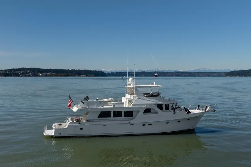 Slide: The Image of 2003 Ocean Alexander 700 Classicco yacht cruising on calm waters under clear skies. - 61