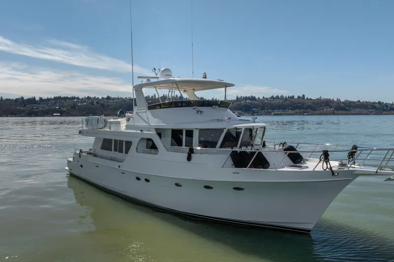 Slide: The Image of 2003 Ocean Alexander 700 Classicco yacht on calm water under clear sky. - 67