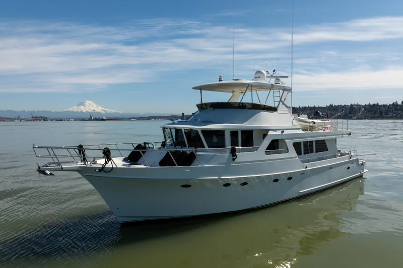 Slide: The Image of 2003 Ocean Alexander 700 Classicco yacht on calm waters with scenic mountain backdrop. - 69