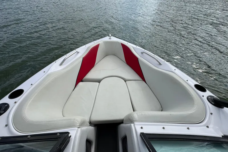 Slide: The Image of 2000 Correct Craft Super Air Nautique boat with white and red seating on water. - 10