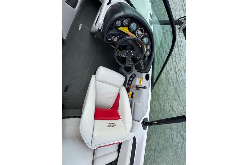 Slide: The Image of 2000 Correct Craft Super Air Nautique boat interior with steering wheel and dashboard. - 11