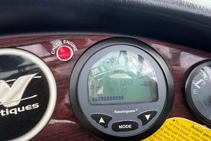 Slide: The Image of Dashboard of a 2000 Correct Craft Super Air Nautique boat with speedometer and check engine light. - 15