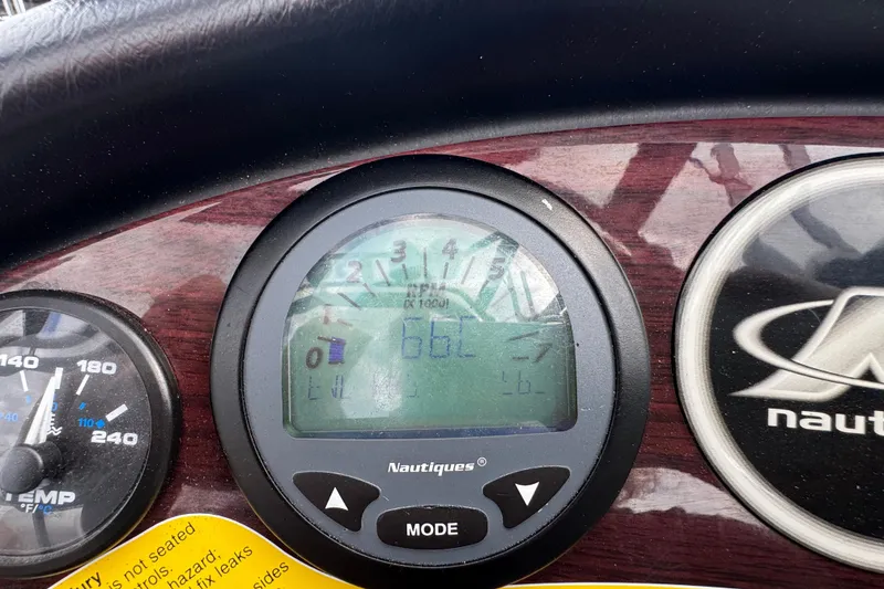 Slide: The Image of Dashboard of 2000 Correct Craft Super Air Nautique boat with digital display and gauges. - 16
