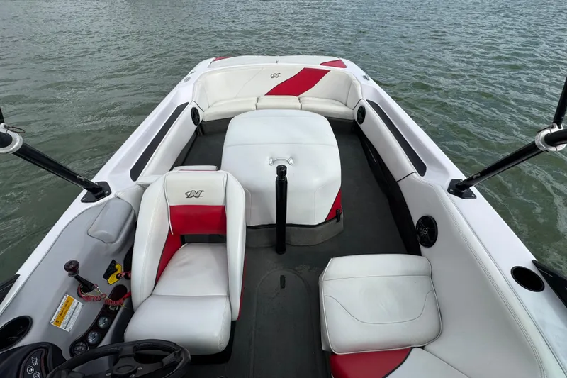 Slide: The Image of 2000 Correct Craft Super Air Nautique boat interior with white and red seating on water. - 17