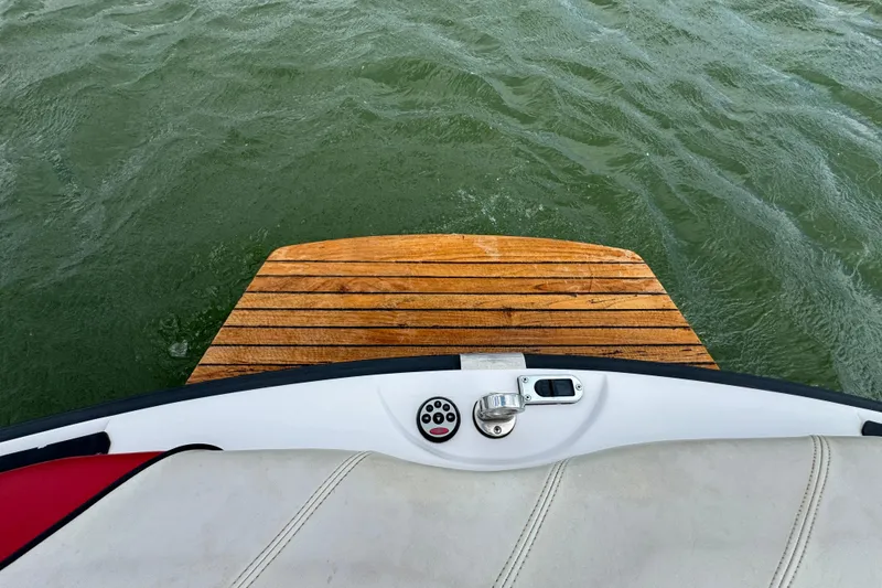 Slide: The Image of Rear view of 2000 Correct Craft Super Air Nautique boat with wooden swim platform. - 21