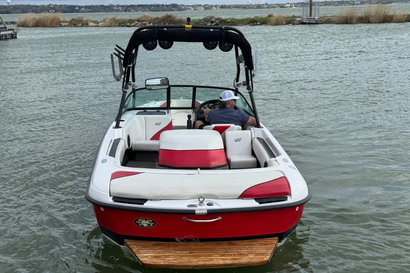 Slide: The Image of 2000 Correct Craft Super Air Nautique boat on water, rear view with driver. - 3