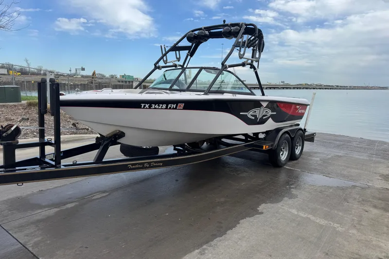 Slide: The Image of 2000 Correct Craft Super Air Nautique boat on trailer by a lake. - 7