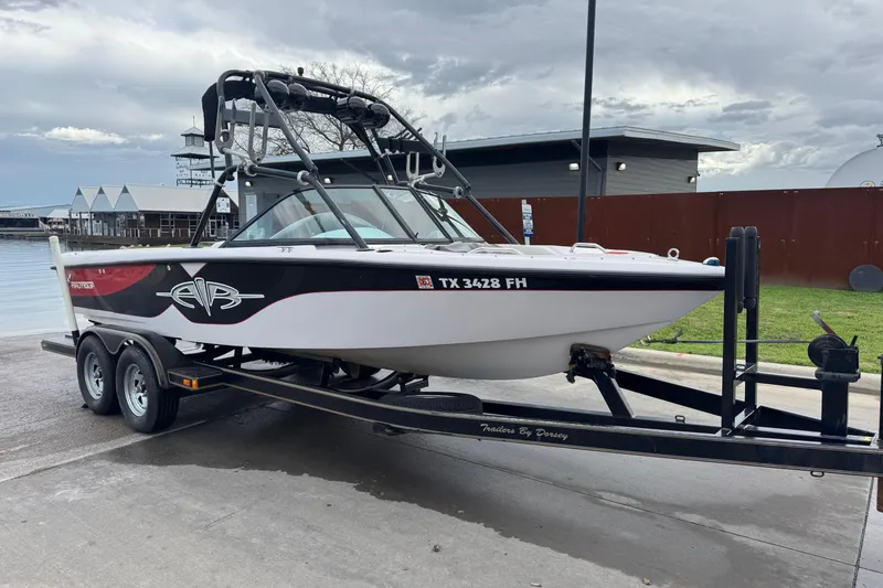 Slide: The Image of 2000 Correct Craft Super Air Nautique boat on trailer by waterfront. - 8