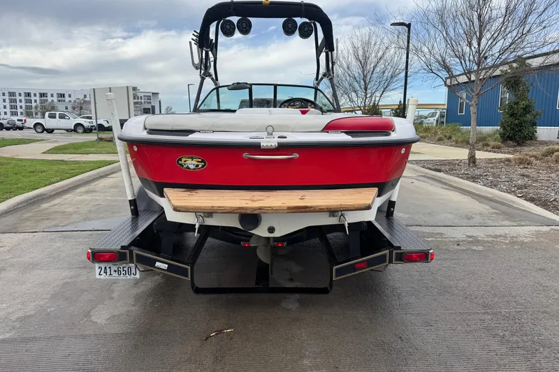 Slide: The Image of 2000 Correct Craft Super Air Nautique boat on trailer, rear view, red and white design. - 9