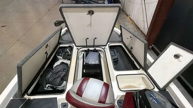 Slide: The Image of 2015 Ranger Z118C boat with open storage compartments and seat. - 16