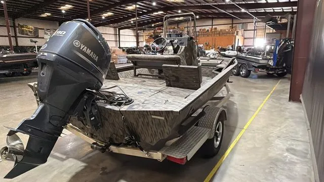 Slide: The Image of 2014 Xpress XP18CC boat with Yamaha 90 engine in warehouse. - 5