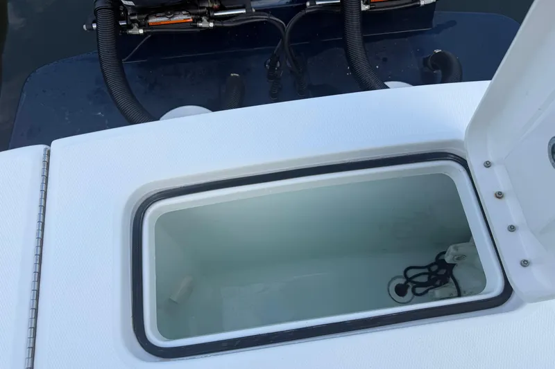 Slide: The Image of Open storage compartment on a 2022 Regulator 23 boat, showing interior details. - 16
