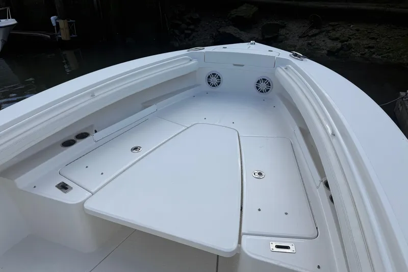Slide: The Image of 2022 Regulator 23 boat interior with white seating and storage compartments. - 17