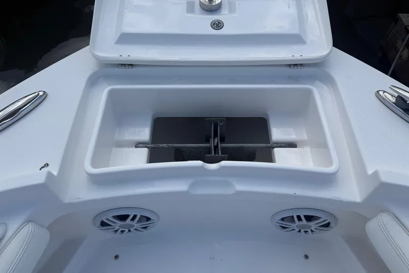 Slide: The Image of 2022 Regulator 23 boat anchor compartment with open lid and visible speakers. - 20