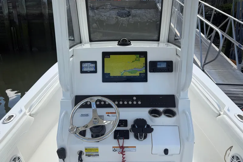 Slide: The Image of 2022 Regulator 23 boat dashboard with navigation system and steering wheel. - 8