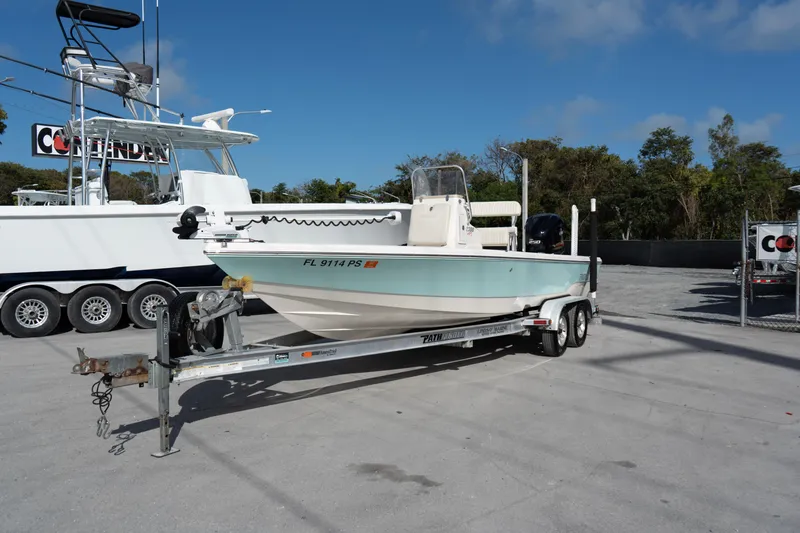 Slide: The Image of 2014 Pathfinder 2300 HPS boat on trailer in outdoor lot, clear sky background. - 2