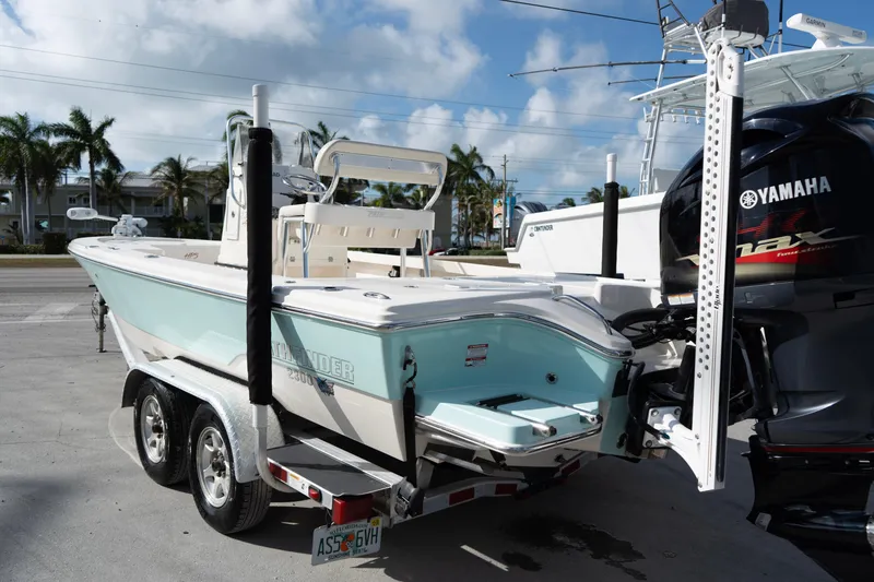 Slide: The Image of 2014 Pathfinder 2300 HPS boat with Yamaha engine on trailer, parked outdoors. - 3