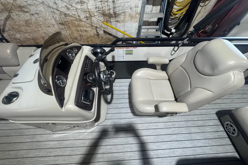 Slide: The Image of Captain's chair and helm of 2018 Trifecta SS 21FC boat, featuring modern controls and dashboard. - 11