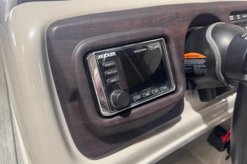 Slide: The Image of 2018 Trifecta SS 21FC boat dashboard featuring Kicker media center controls. - 15