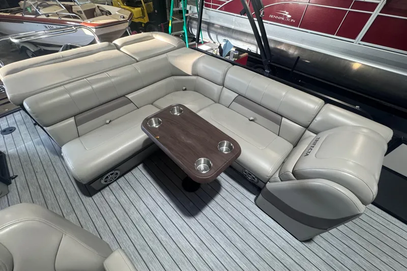 Slide: The Image of Luxurious seating area on 2018 Trifecta SS 21FC pontoon boat with table and cup holders. - 16