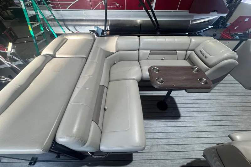 Slide: The Image of 2018 Trifecta SS 21FC pontoon boat interior with gray seating and table. - 17