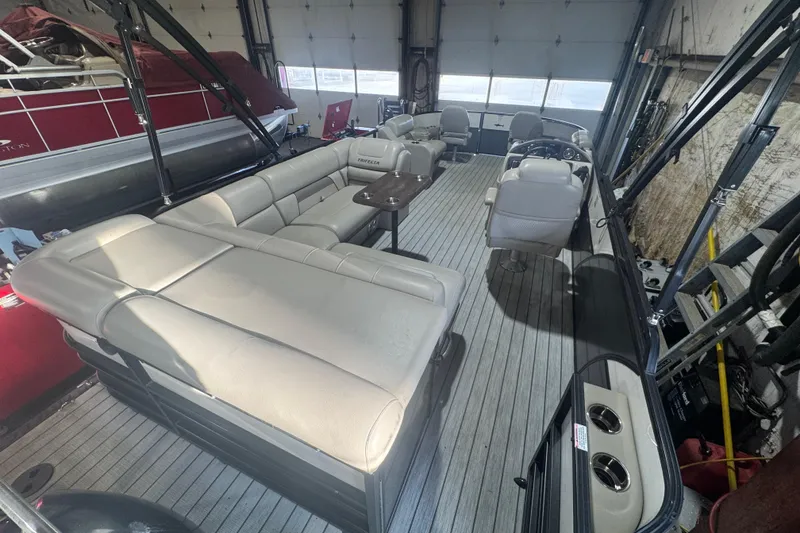 Slide: The Image of 2018 Trifecta SS 21FC pontoon boat interior with beige seating and steering console. - 18