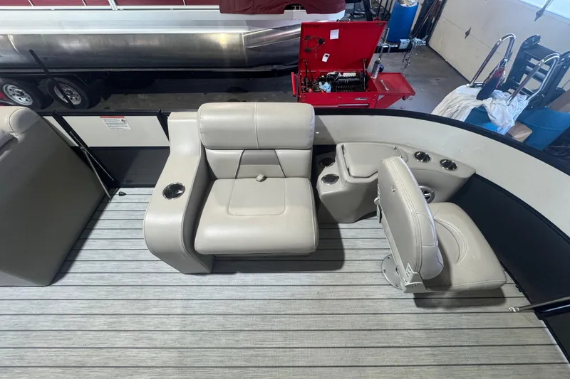 Slide: The Image of 2018 Trifecta SS 21FC pontoon boat interior with beige seating and cup holders. - 9