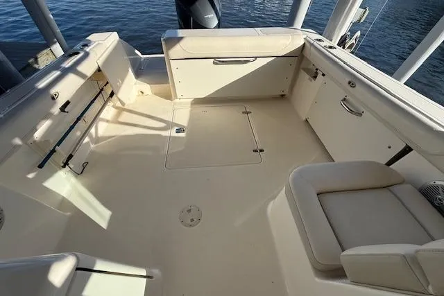 Slide: The Image of 2011 Pursuit DC 265 Dual Console boat interior with spacious seating and storage. - 11