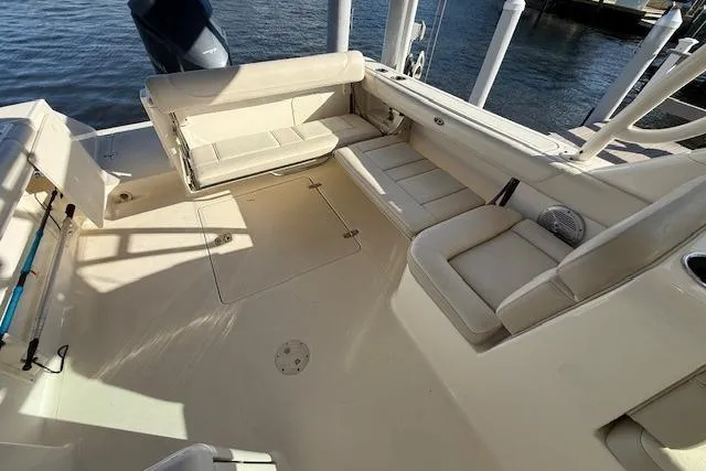 Slide: The Image of 2011 Pursuit DC 265 Dual Console boat interior with beige seating and spacious deck. - 12