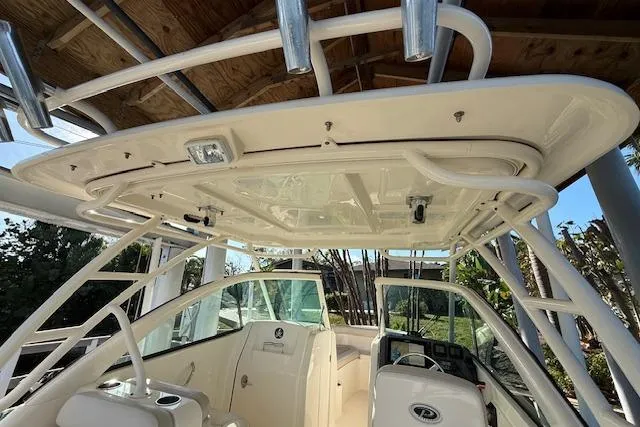 Slide: The Image of 2011 Pursuit DC 265 Dual Console boat interior with helm and seating area. - 14