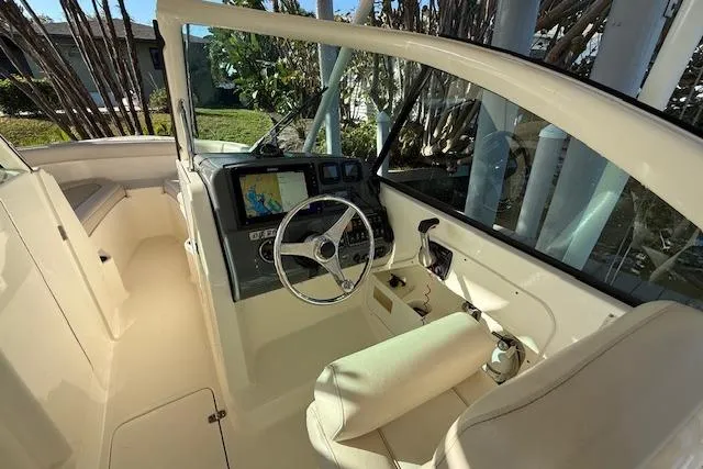 Slide: The Image of 2011 Pursuit DC 265 Dual Console boat interior with steering wheel and navigation system. - 19