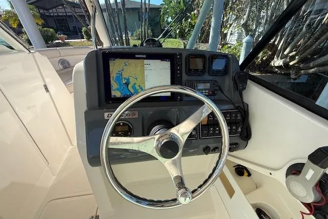 Slide: The Image of Steering console of a 2011 Pursuit DC 265 Dual Console boat with navigation display. - 20