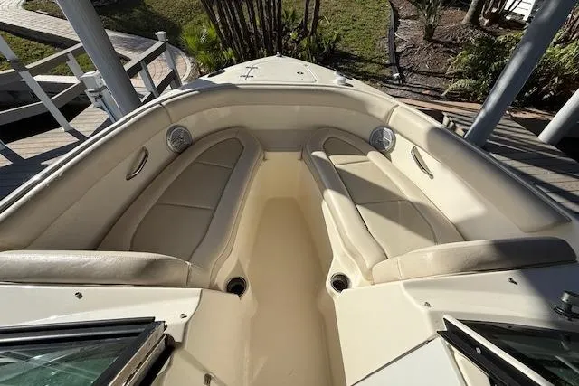 Slide: The Image of 2011 Pursuit DC 265 Dual Console boat with beige seating and spacious deck area. - 21