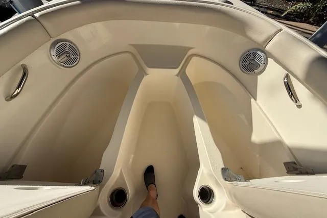 Slide: The Image of 2011 Pursuit DC 265 Dual Console boat interior with seating and speakers. - 22
