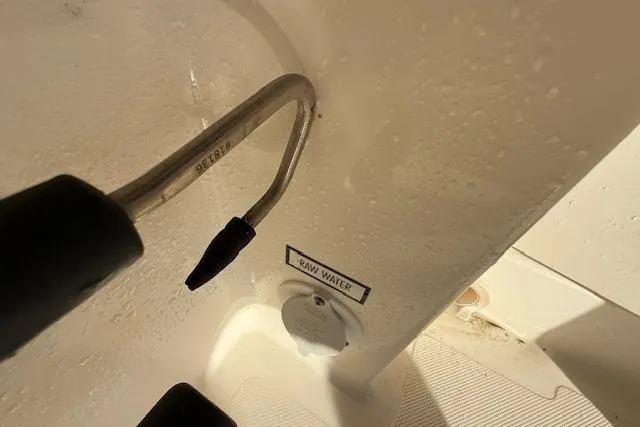 Slide: The Image of Close-up of a 2011 Pursuit DC 265 Dual Console's raw water outlet. - 27