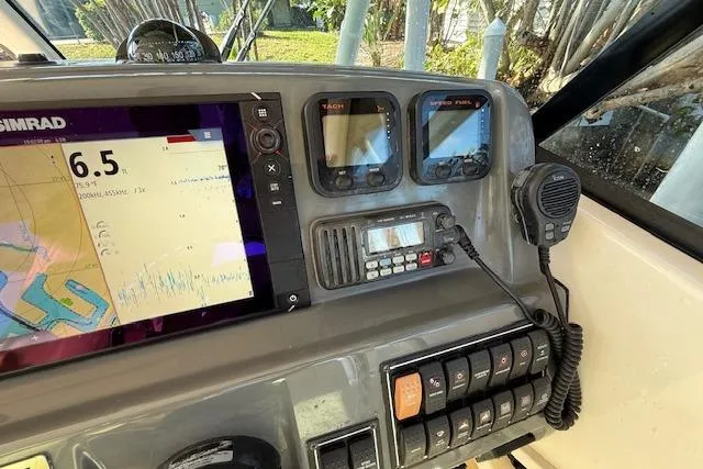 Slide: The Image of 2011 Pursuit DC 265 Dual Console dashboard with navigation and communication equipment. - 33