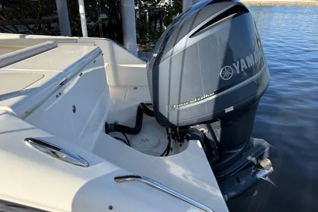 Slide: The Image of 2011 Pursuit DC 265 Dual Console with Yamaha outboard motor on calm water. - 6