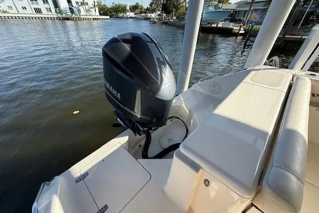 Slide: The Image of 2011 Pursuit DC 265 Dual Console boat with Yamaha outboard motor on a calm waterway. - 8