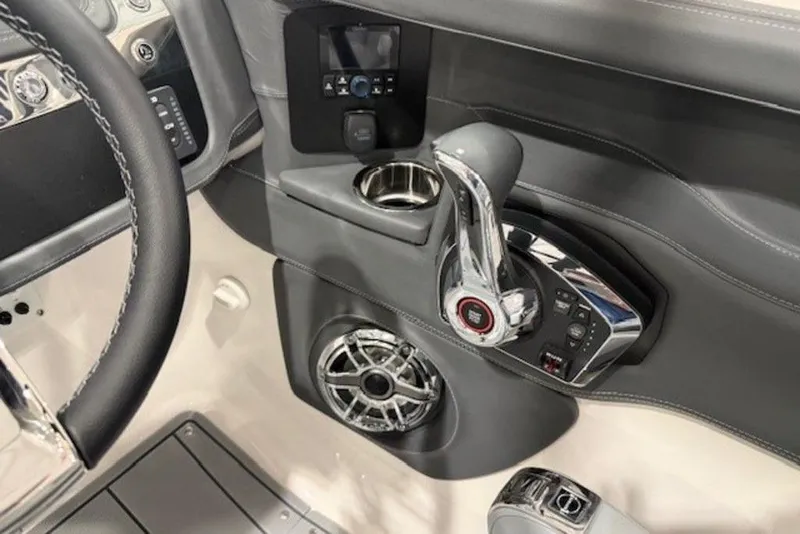 Slide: The Image of Interior of 2026 Chaparral 270 OSX boat, featuring steering wheel and control panel. - 16