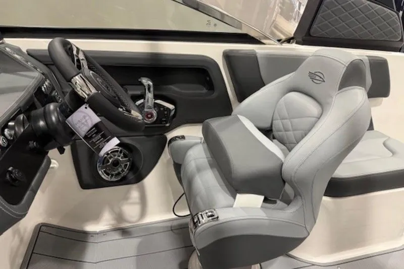 Slide: The Image of 2026 Chaparral 270 OSX boat cockpit with modern steering wheel and luxurious seating. - 17
