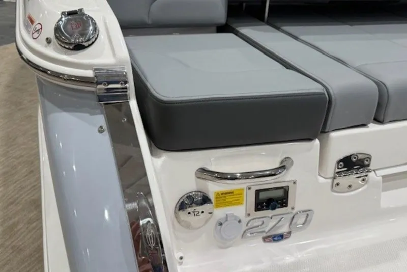Slide: The Image of 2026 Chaparral 270 OSX boat with gray seating and control panel. - 19