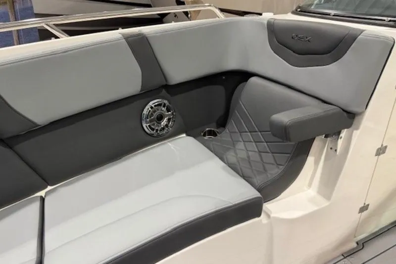 Slide: The Image of 2026 Chaparral 270 OSX boat interior with gray seating and speaker detail. - 24