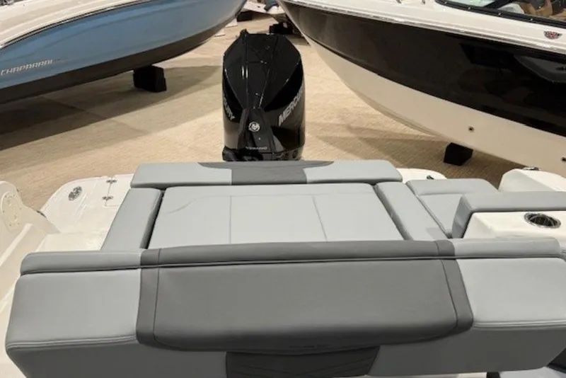 Slide: The Image of 2026 Chaparral 270 OSX boat interior with sleek seating and powerful outboard motor. - 9