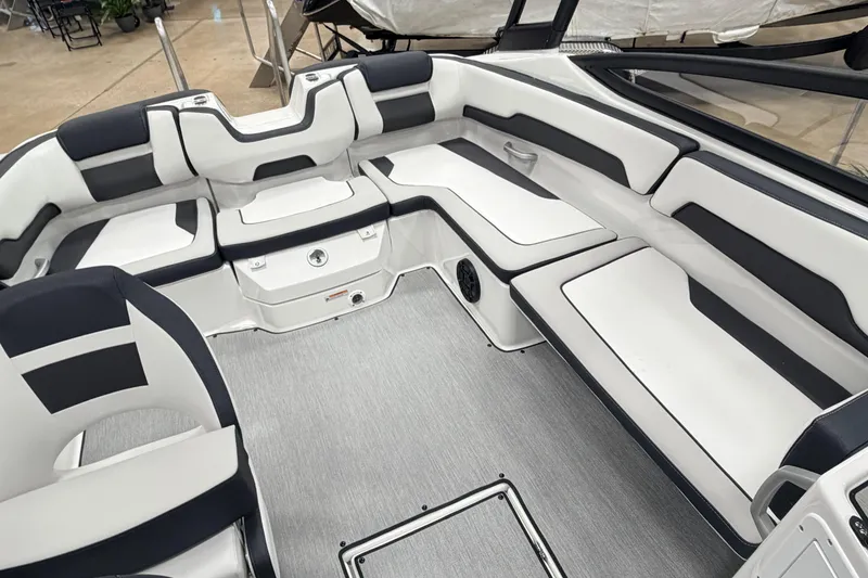 Slide: The Image of 2026 Yamaha Boats AR195 interior with sleek white and black seating, showcasing modern design. - 11