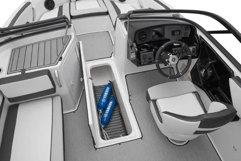 Slide: The Image of 2026 Yamaha Boats AR195 interior with steering wheel, seating, and storage compartment. - 17