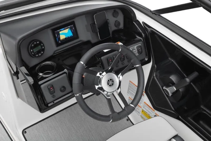 Slide: The Image of 2026 Yamaha Boats AR195 dashboard with steering wheel, digital display, and controls. - 18